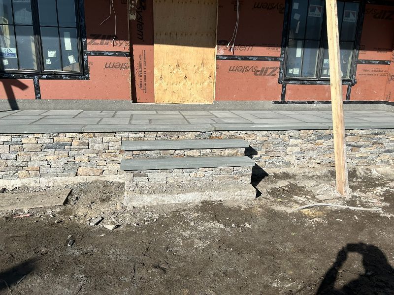 A building under construction with a wooden door and steps
