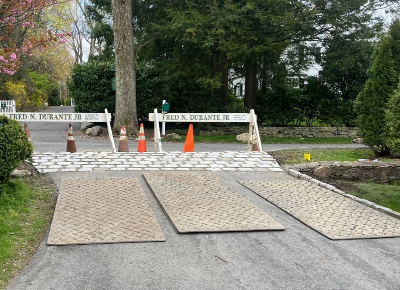 A road with a brick barrier and cones on it