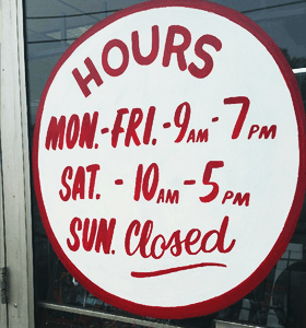 Store front door with business hours