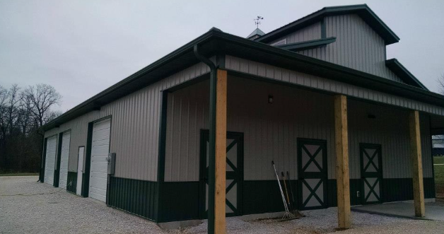 A large building with a porch and a lot of doors.