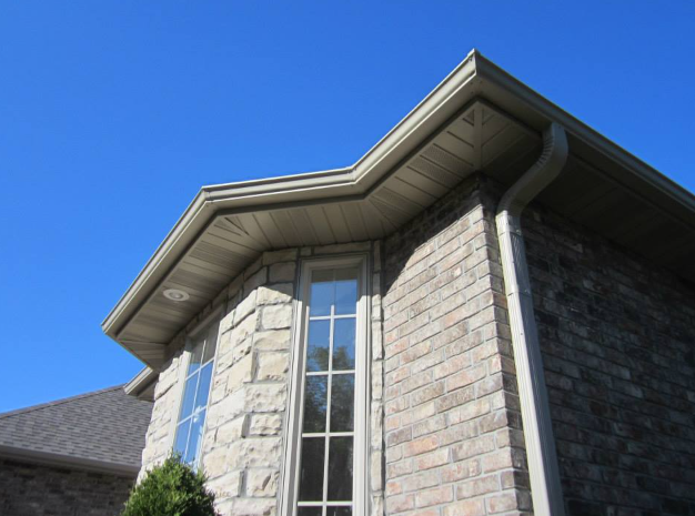 A brick house with a gutter and a window