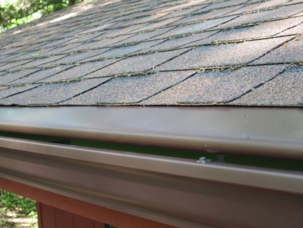 A close up of a roof with a gutter on it.