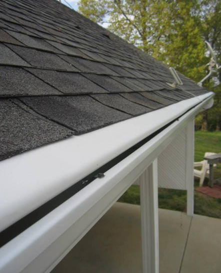 A close up of a roof with a white gutter