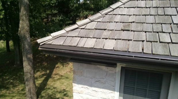 A house with a wooden roof and a gutter.