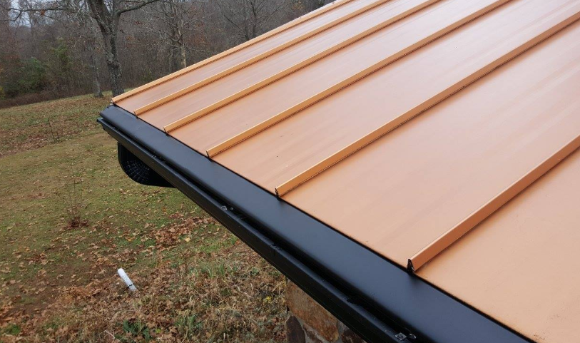 A close up of a roof with a black gutter
