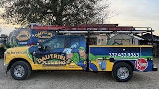 Colorful plumbing service van with ladder rack, parked outdoors against a stone wall.