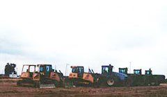 Seven blue and yellow excavators