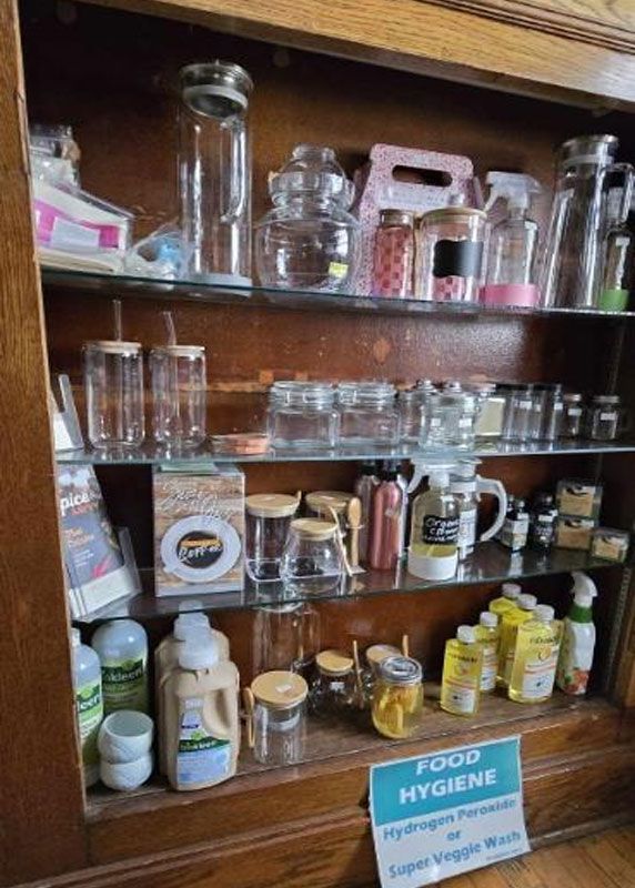 A shelf filled with jars, bottles, and a sign that says food hygiene.
