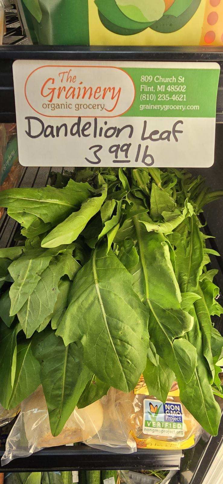 A bag of dandelion leaf is on a shelf in a grocery store.
