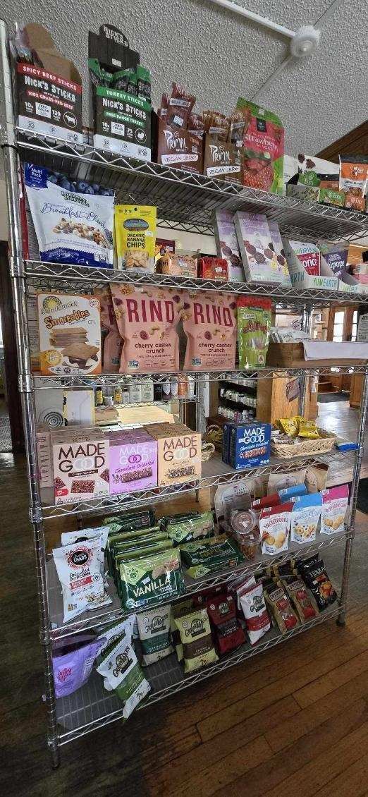 A store shelf filled with lots of food and snacks.