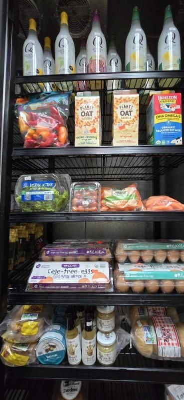 A refrigerator filled with lots of food and cleaning supplies.