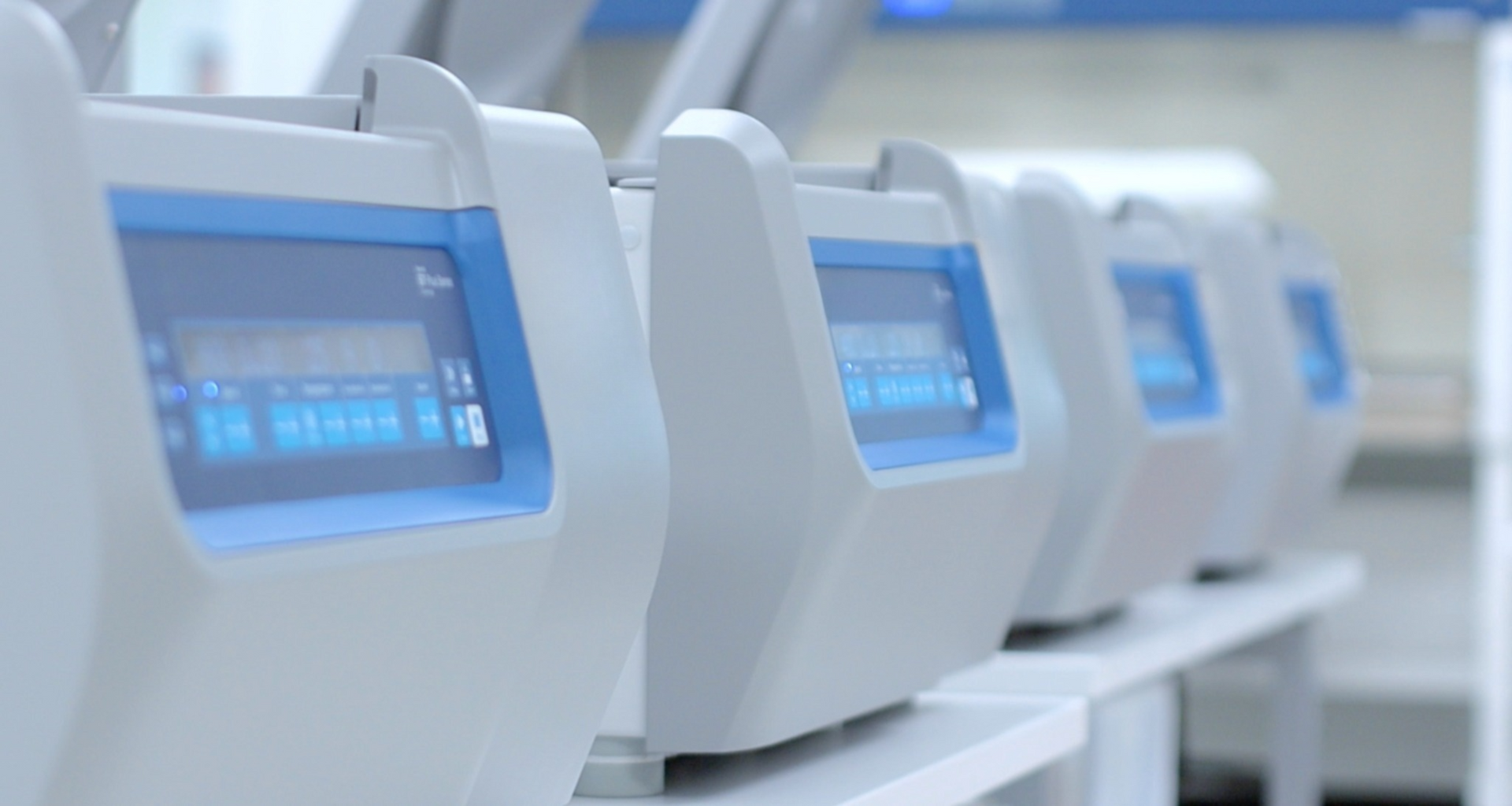 Row of centrifuges for cellular processing at PK4 Labs