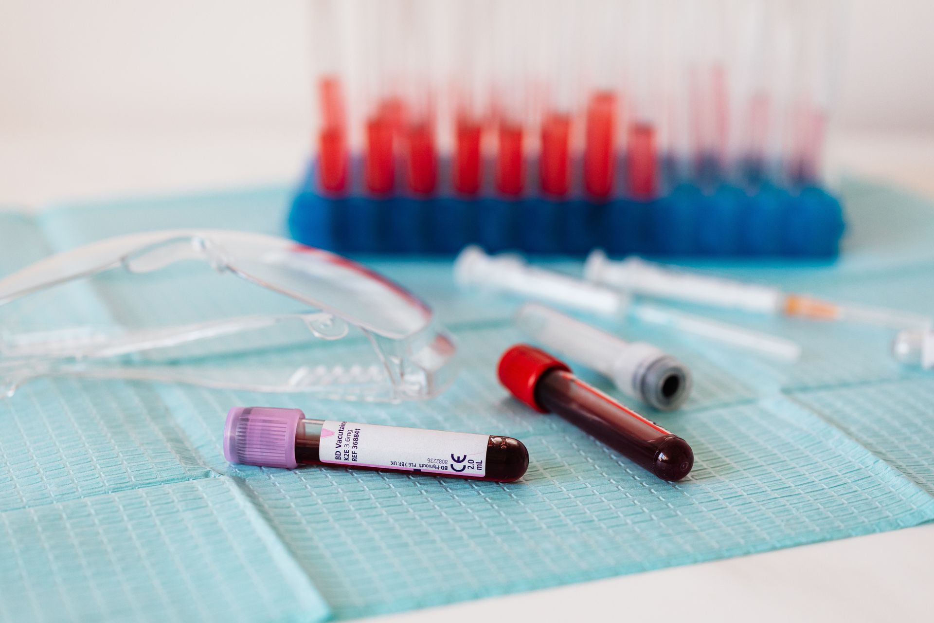 Laboratory setup with a researcher examining blood samples, highlighting PBMC research.