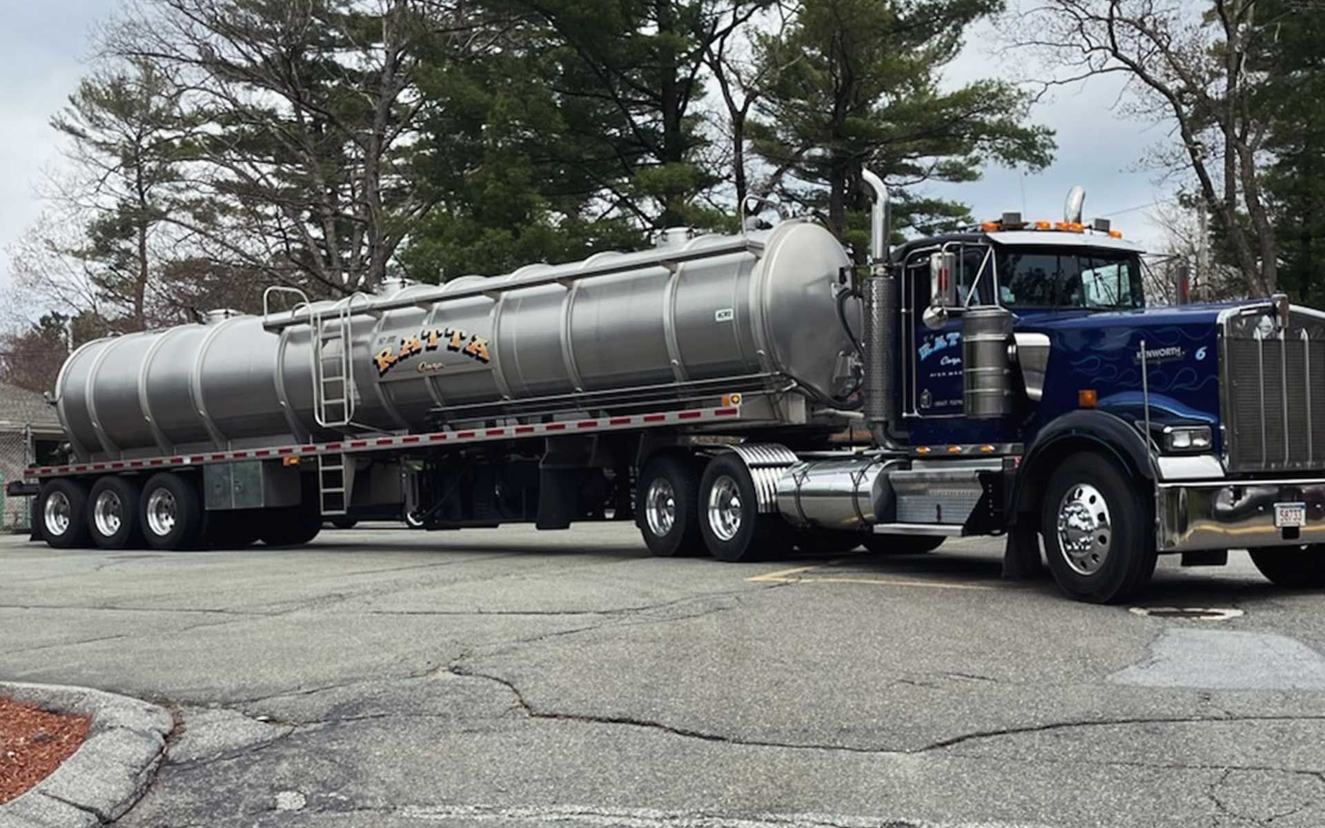 A large tanker truck is parked in a parking lot