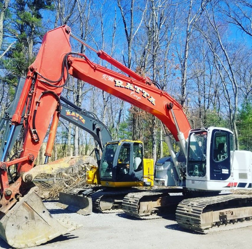 A red excavator with the word batta on it