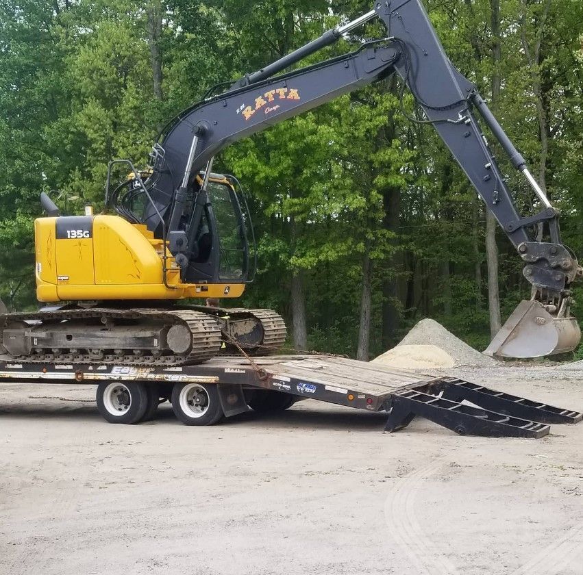 A yellow excavator with the word matta on it