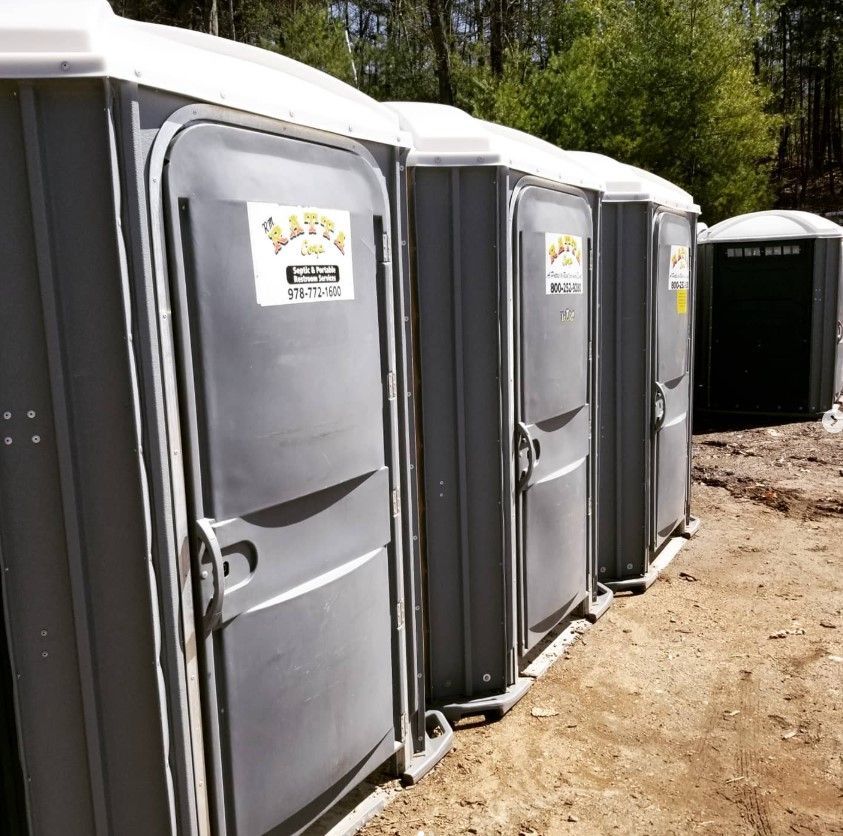 A row of portable toilets are lined up next to each other
