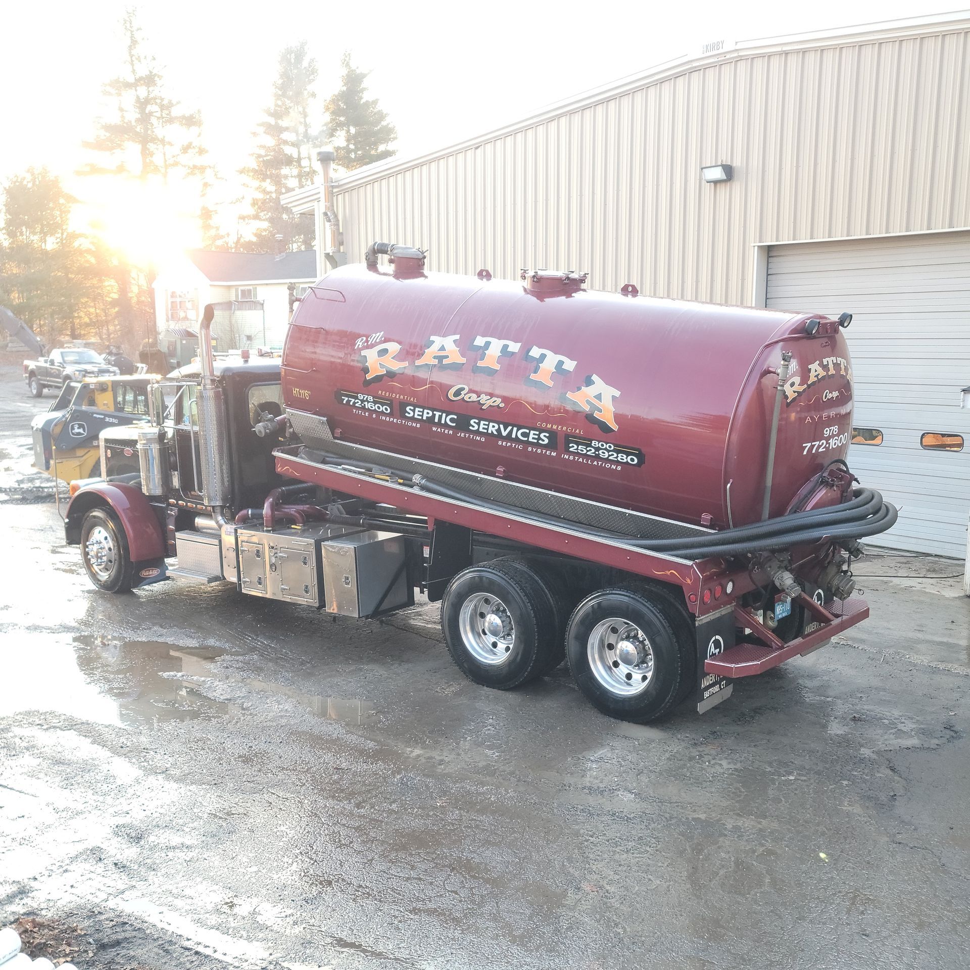 A maroon tanker truck with the name