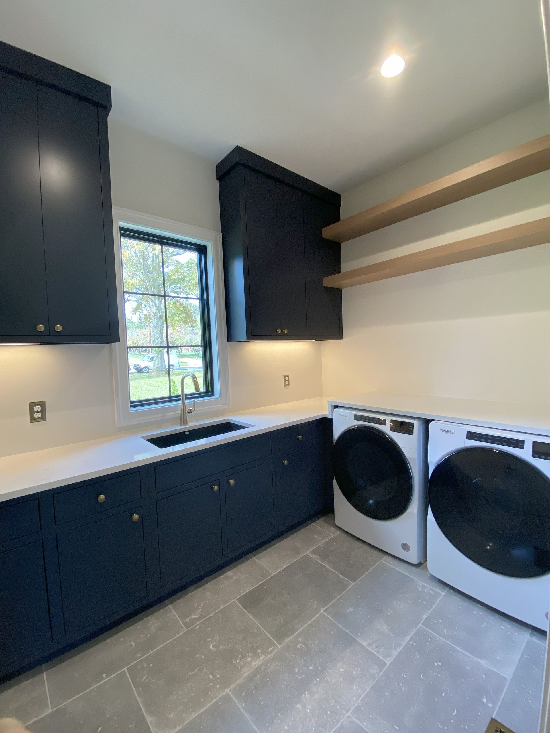 A laundry room with a washer and dryer and a sink