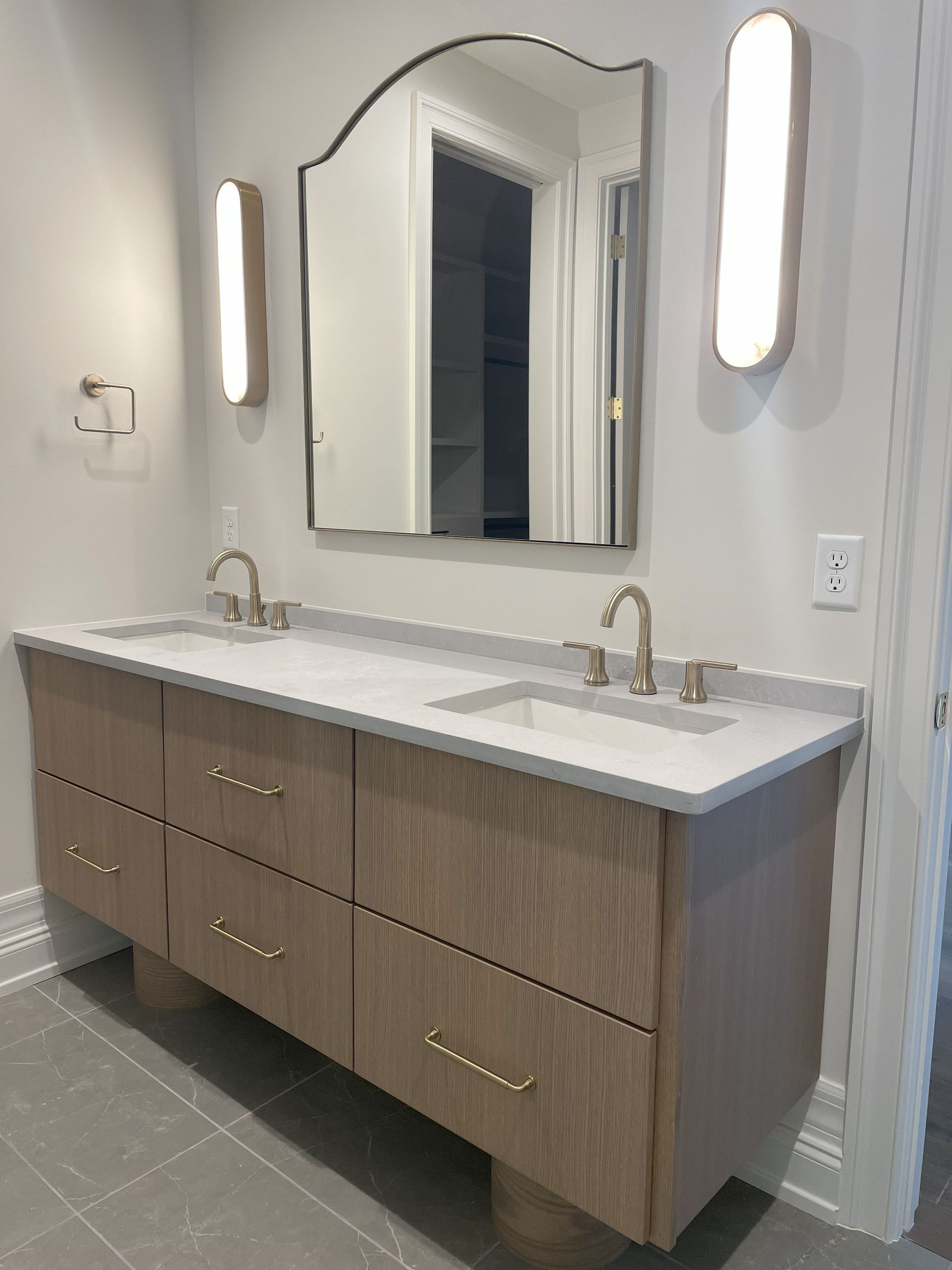 A bathroom with two sinks and a large mirror.