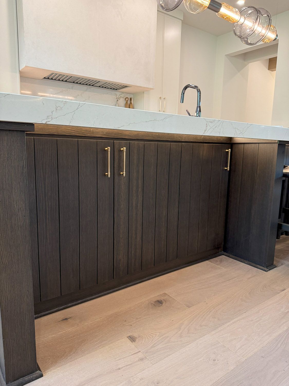 A kitchen with wooden cabinets and a marble counter top.