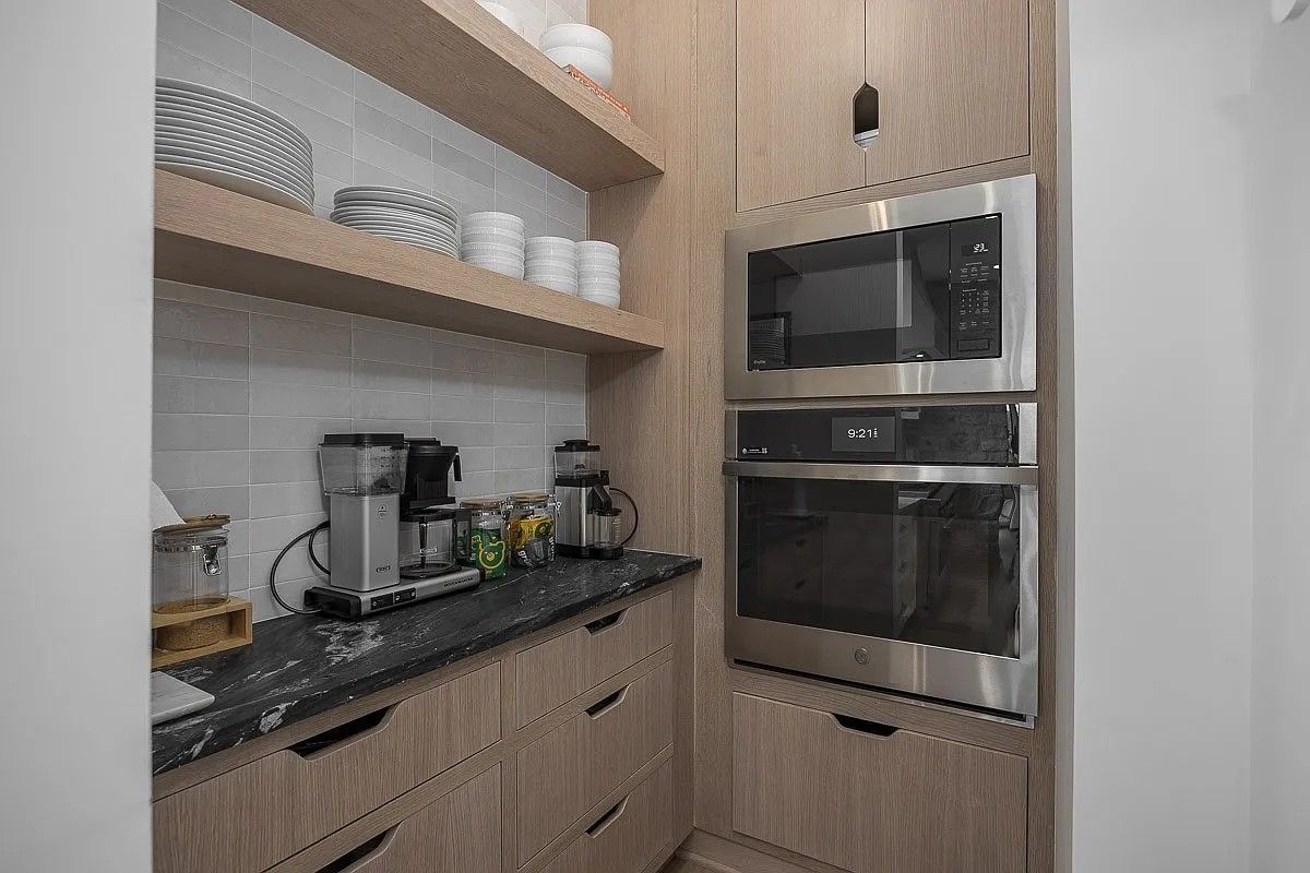 A kitchen with stainless steel appliances and wooden cabinets.