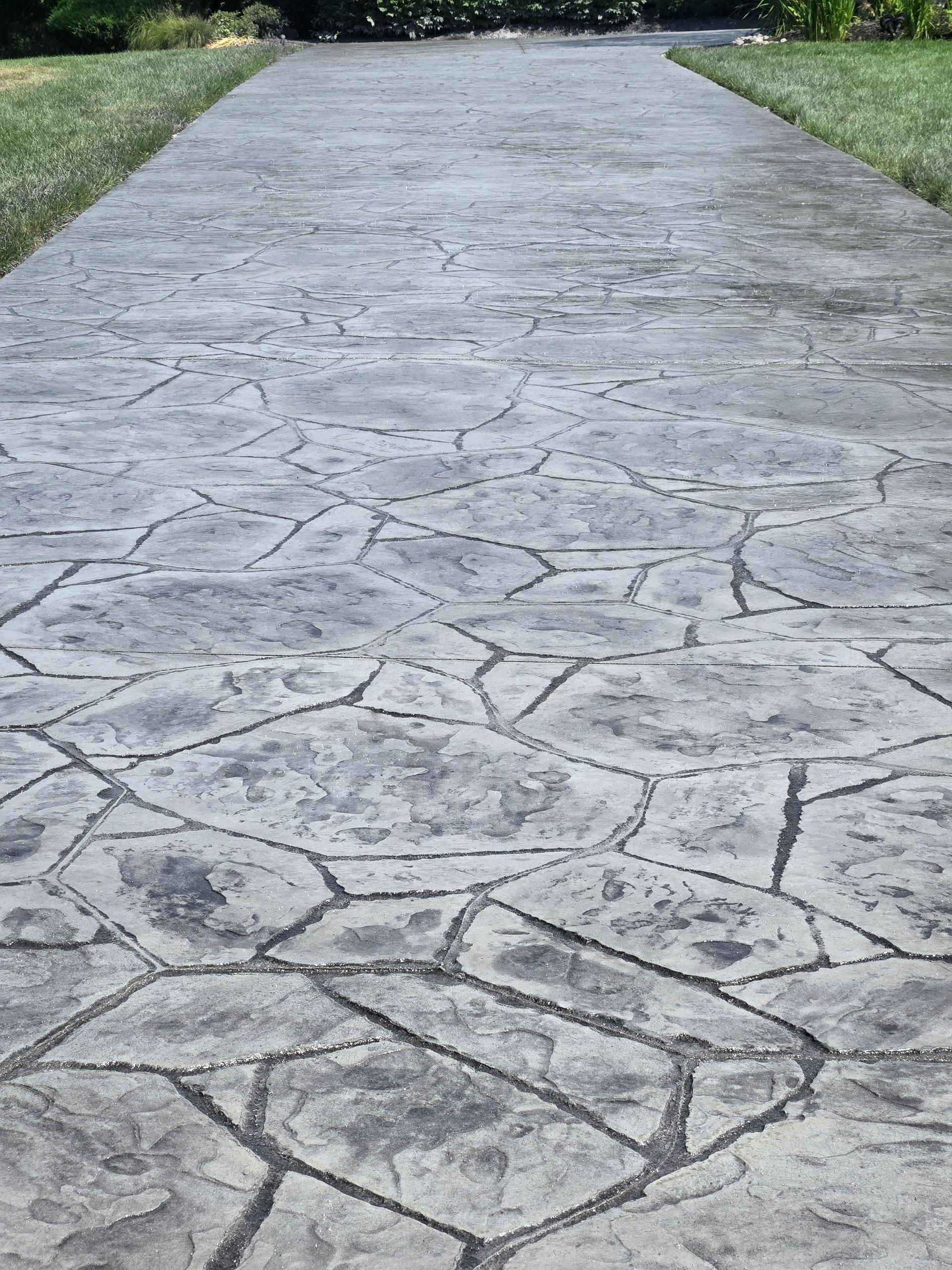 A concrete walkway with a geometric pattern