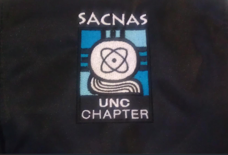 A black shirt with a sacnas logo on it