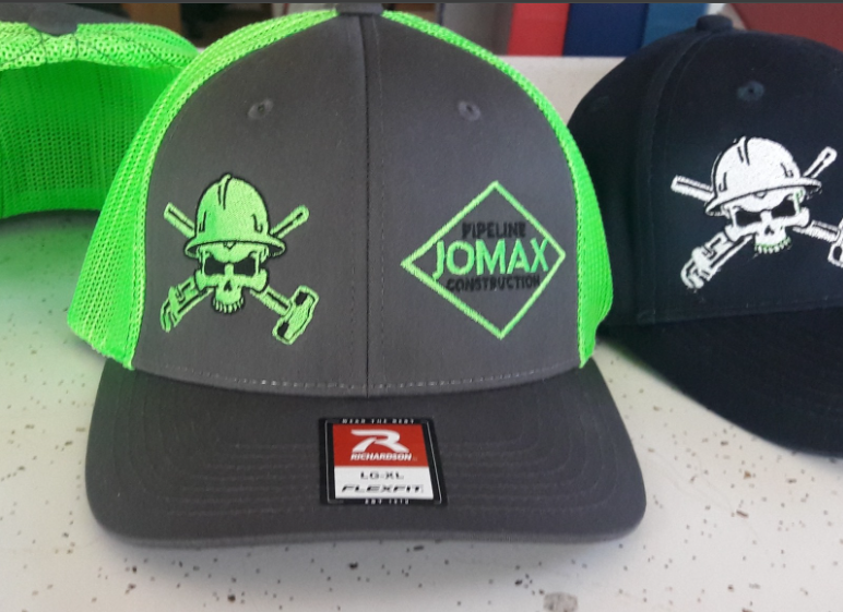 Two jomax hats are sitting on a table