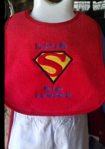 A red bib with a superman logo on it