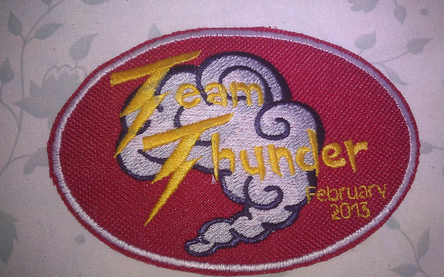 A red patch that says team thunder february 2013