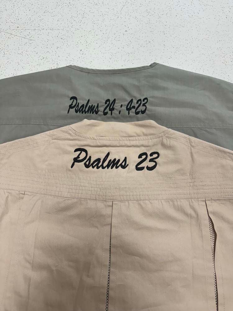 Tan and gray jackets with embroidered text in black.