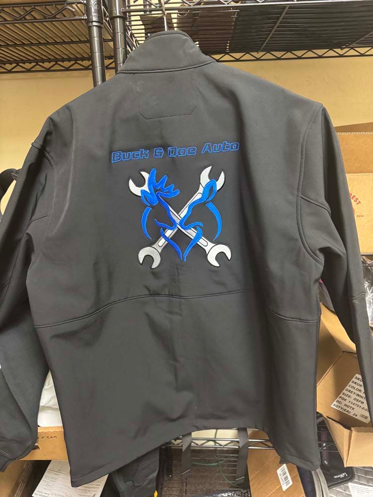 Black jacket with crossed wrenches, a heart, and text reading Kings & Queen's Garage.