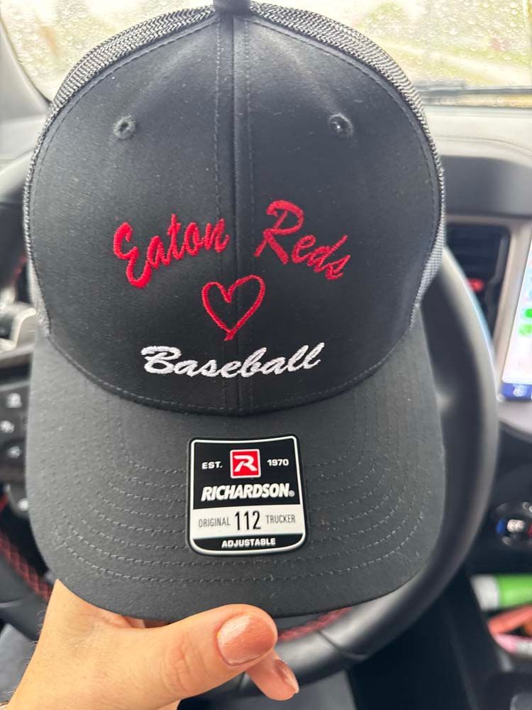 Black hat with Eaton Reds in red script.