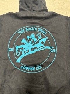 Cowboy on bucking horse holding coffee.