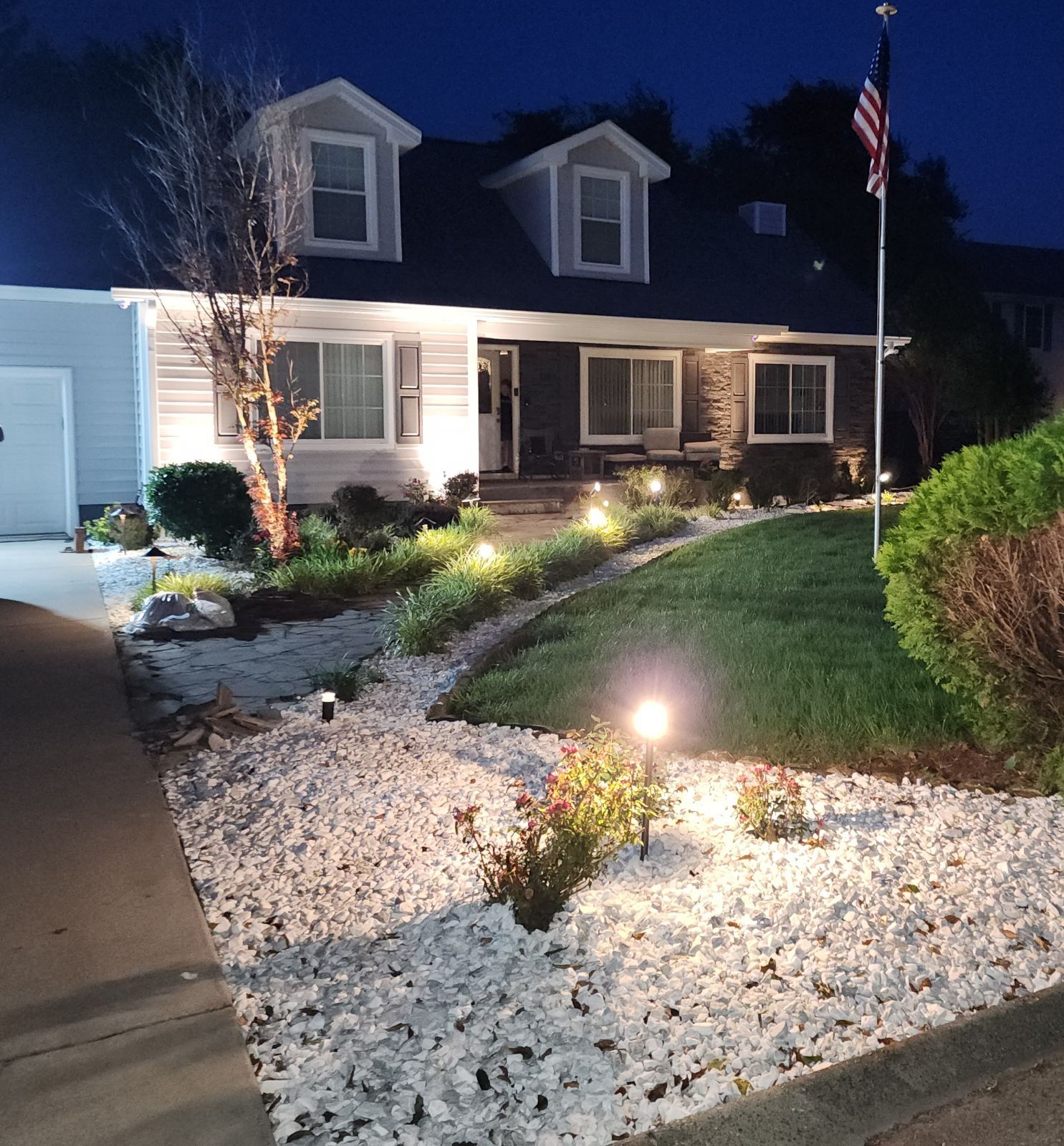A house with a flag in front of it at night