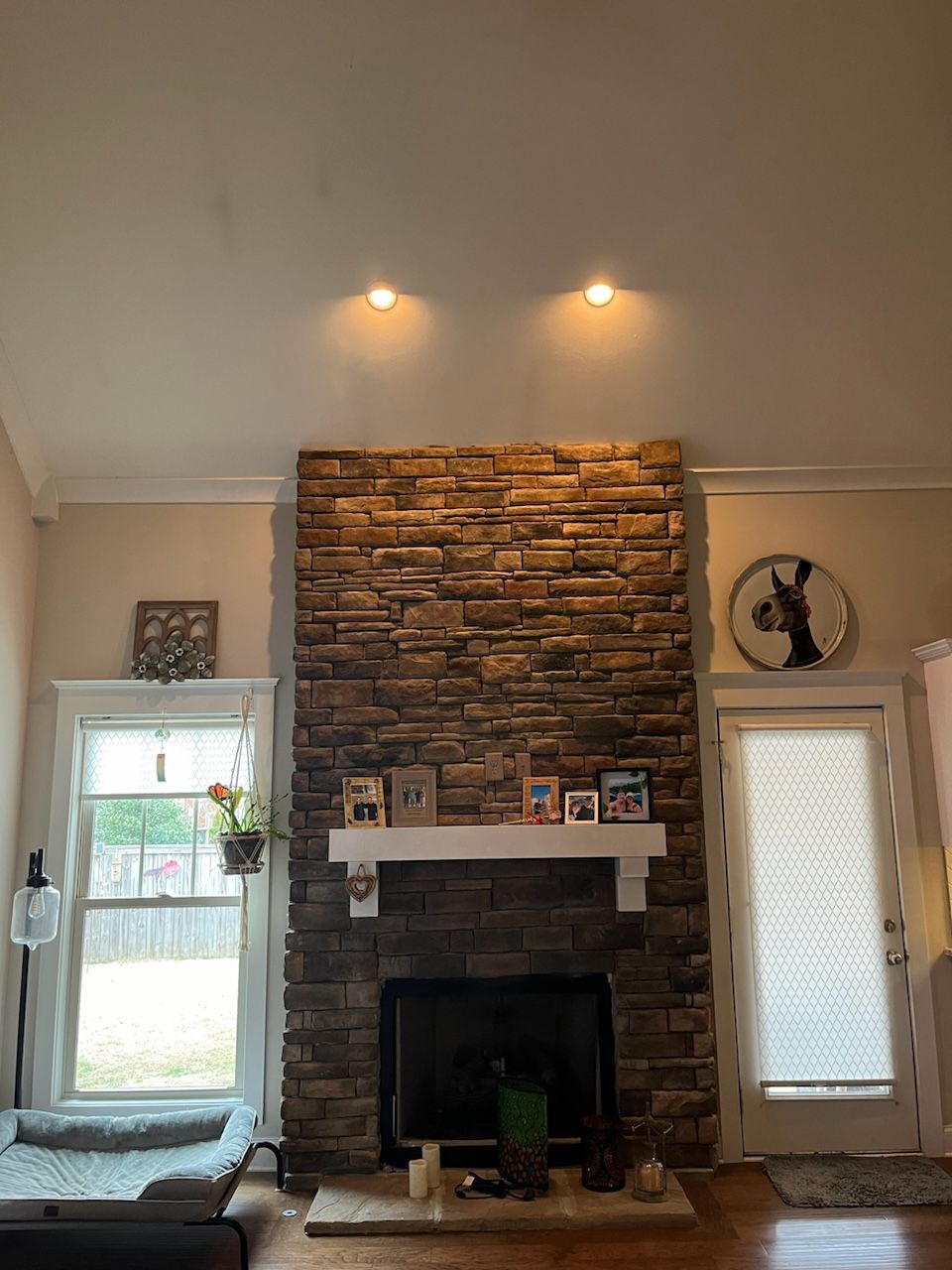 A living room with a fireplace and a stone wall.