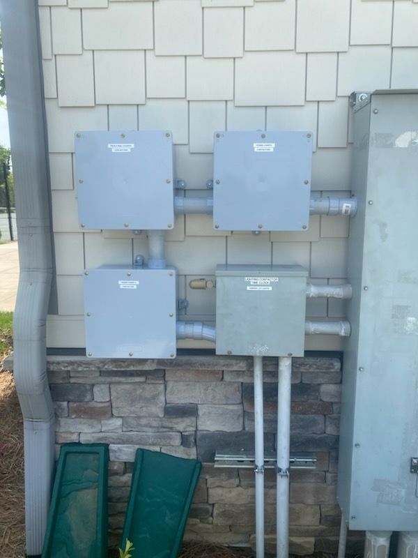 A row of electrical boxes on the side of a building