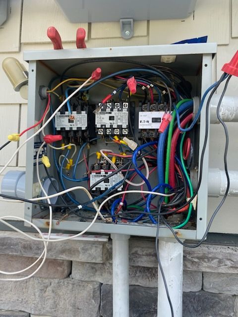 An electrical box with a lot of wires coming out of it
