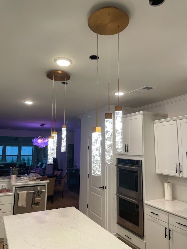 A kitchen with white cabinets and a stainless steel oven