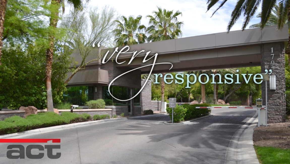 Gated community entrance with very responsive overlay text. Lush greenery and palm trees.