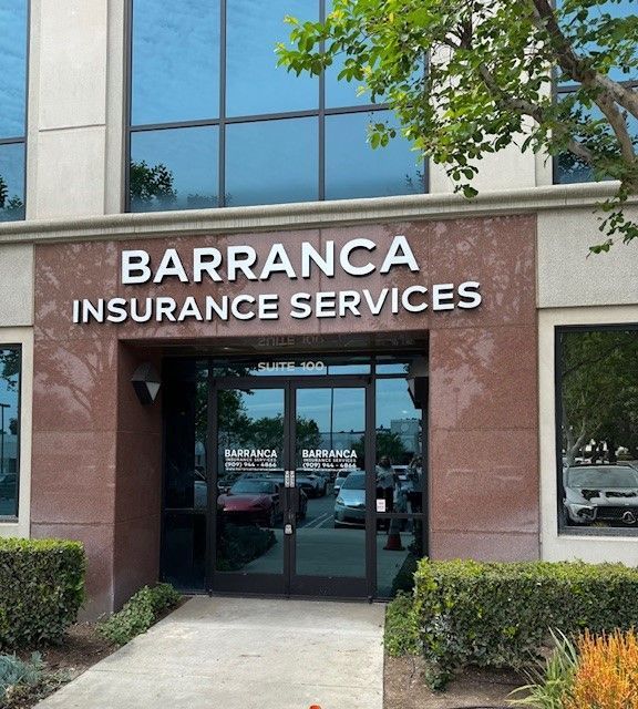 Barranca Insurance Services storefront with glass doors and tan facade