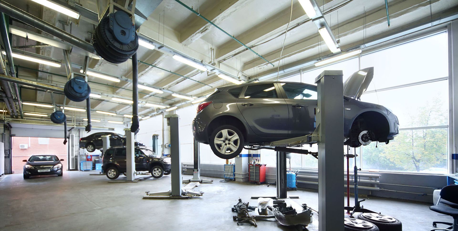A car is sitting on a lift in a garage