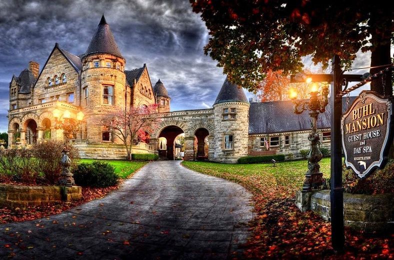 A castle with a sign in front of it that says
