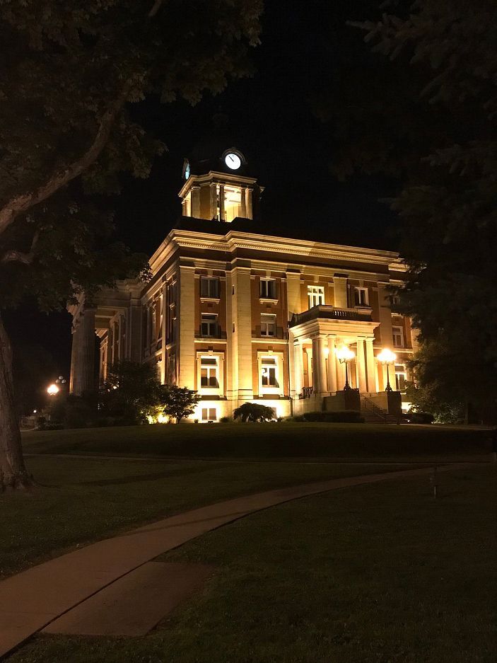 A large brick building is lit up at night