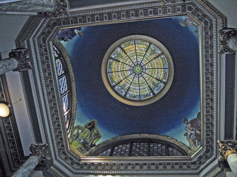 A ceiling with a stained glass window in the middle