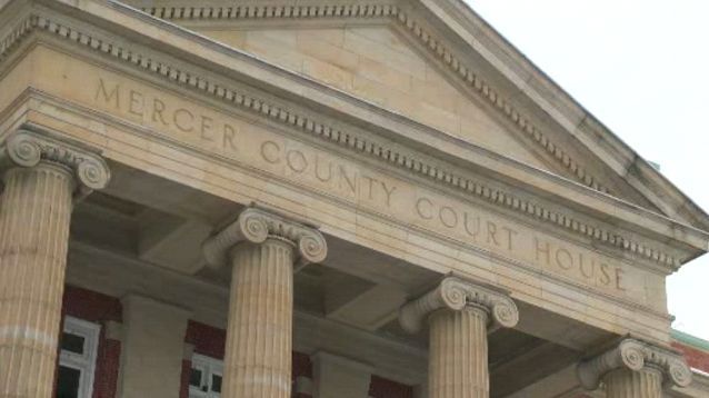 The front of a mercer county courthouse with columns and a roof.