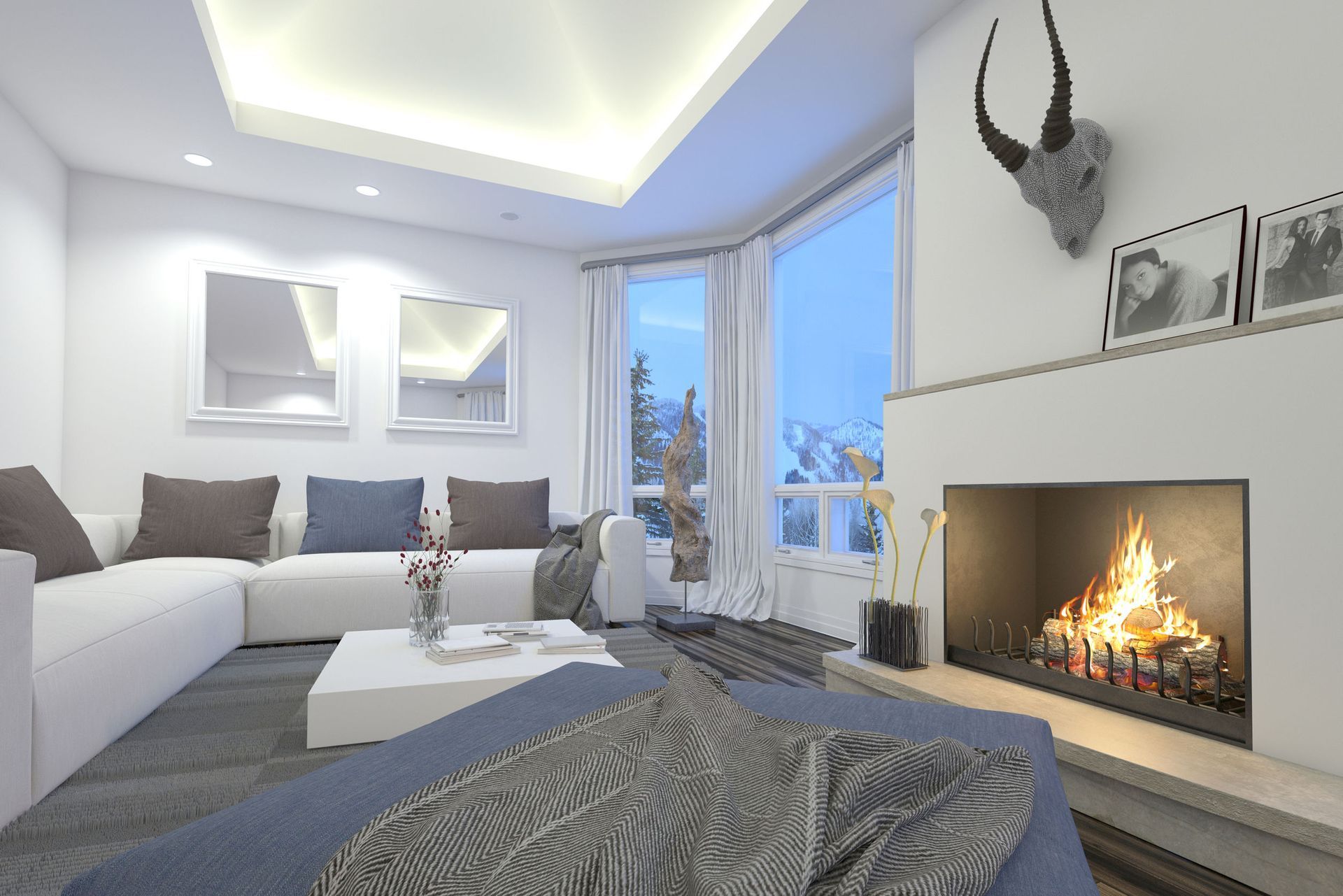 Modern living room with white sectional sofa, fireplace, large windows, and mounted deer head decor