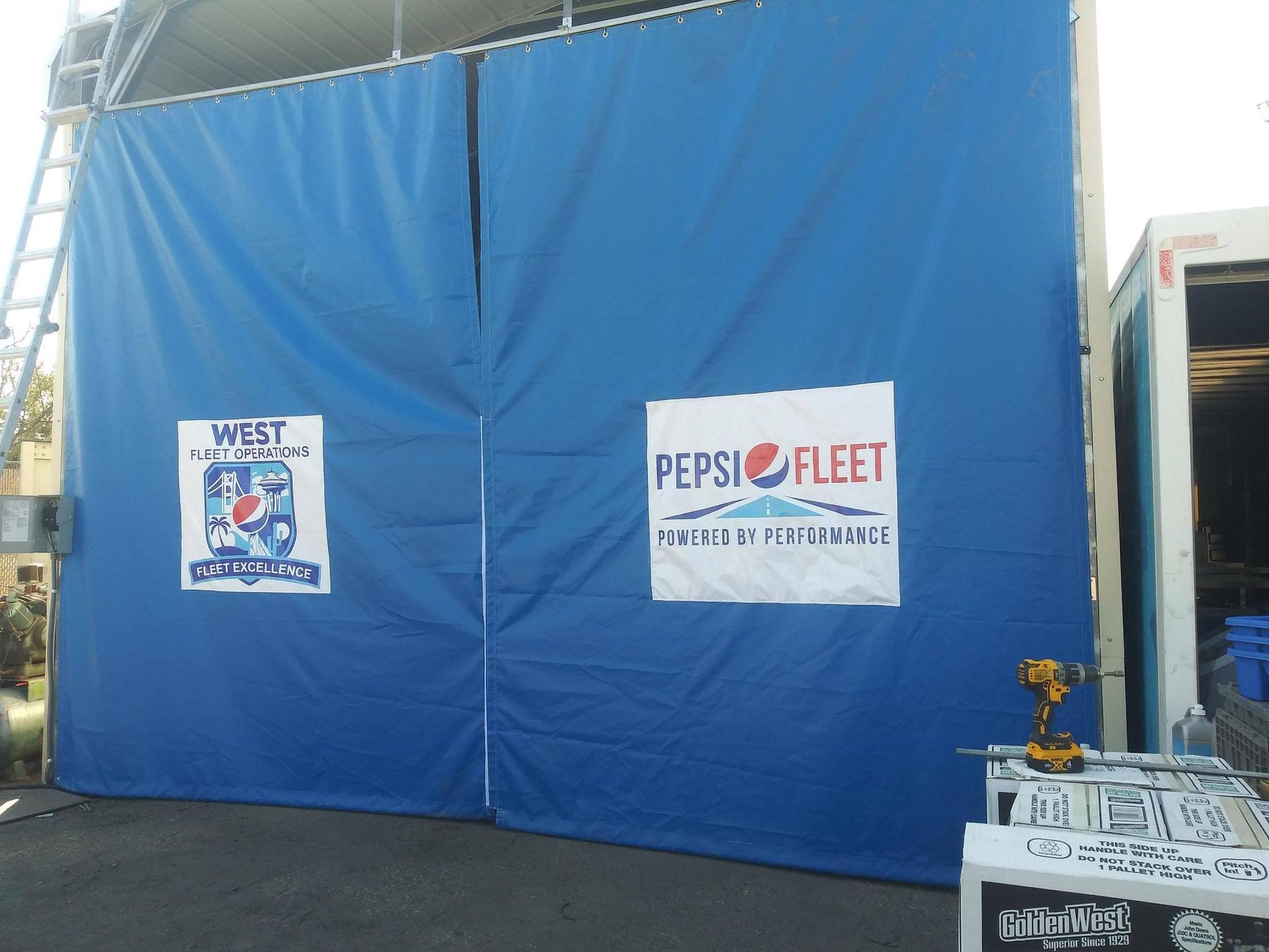 Blue tarp doors with logos for 