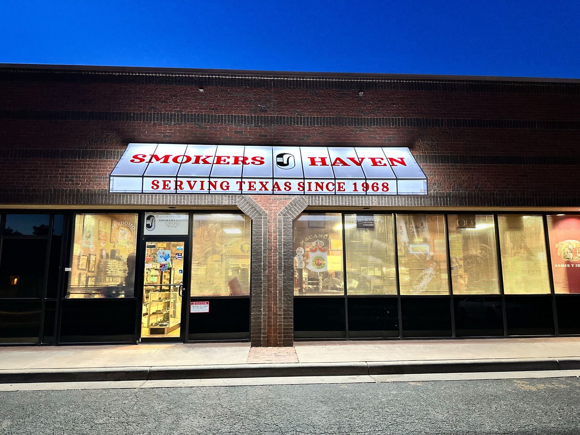 Smokers' Haven store front with illuminated sign: 